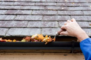 man cleaning gutter