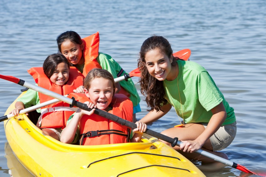 Family enjoying kayaking at summer camp