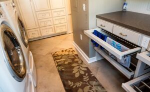 Modern laundry room with sleek washer, dryer, and organized storage, showcasing a clean and stylish setup.