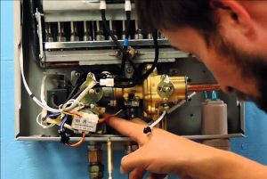 Technician inspecting a tankless water heater.