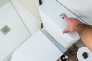 Man discussing the importance of using a low-flow toilet to save water.