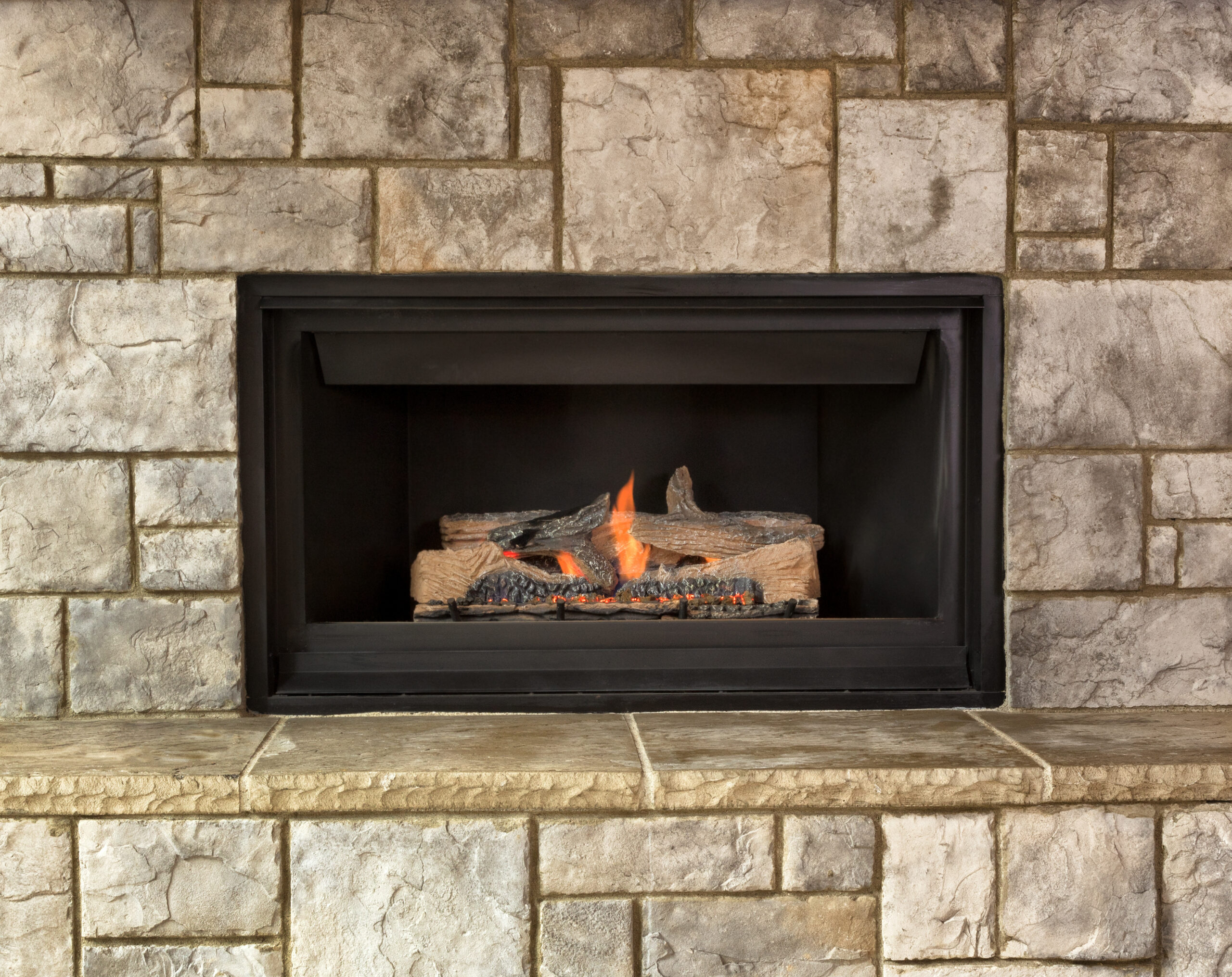 Gas fireplace insert emitting warm glow