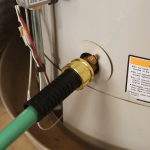 Water heater being flushed with a hose