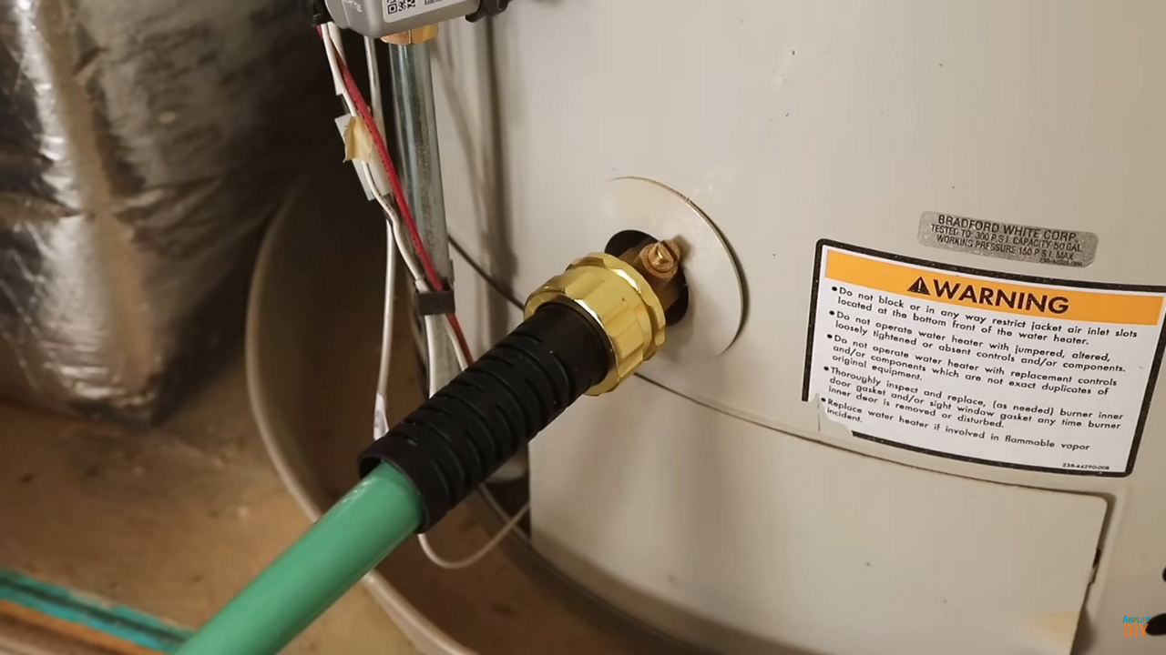 Water heater being flushed with a hose