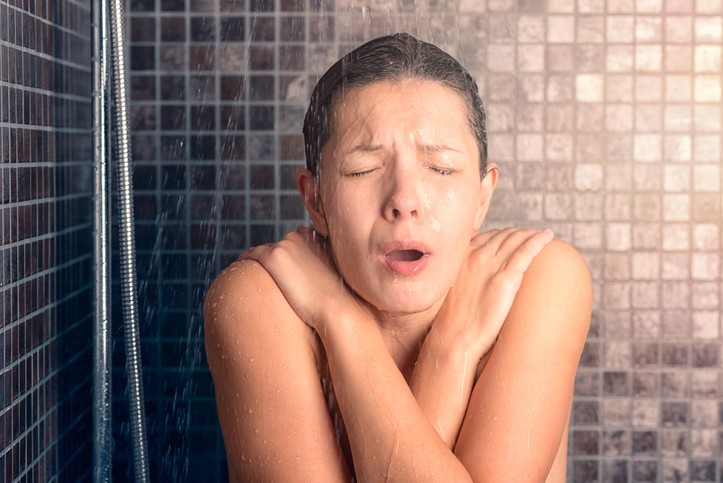 Girl feeling hot while bathing with aging water heater